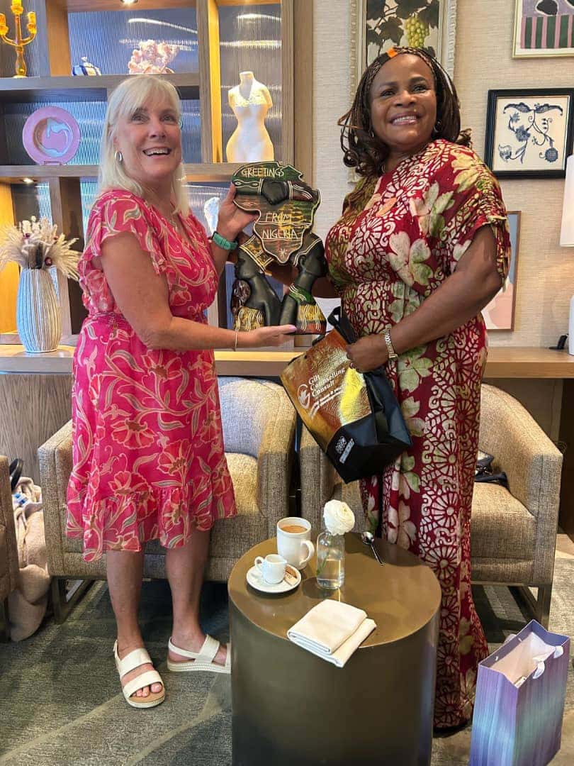 Tracy Heath holding a Nigerian gift plaque presented by Gilt Counselling Consult - Event photo 2
